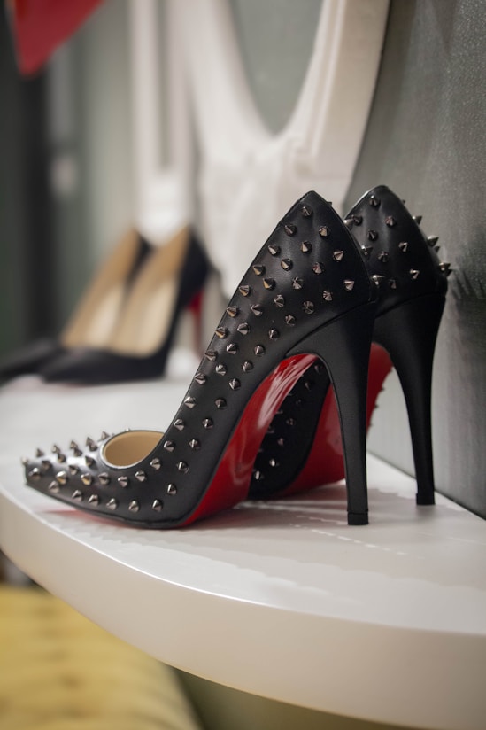 a pair of black and red high heeled shoes