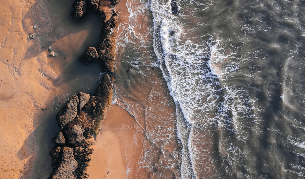 an aerial view of a sandy beach and ocean