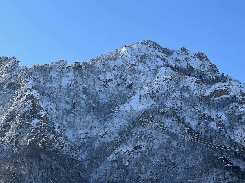 a snow covered mountain with a ski lift in the foreground