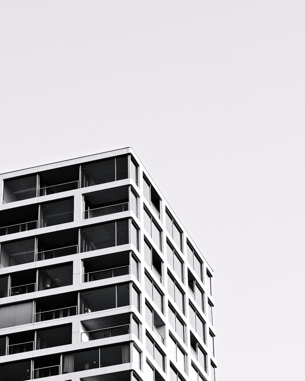 a tall building with balconies on top of it