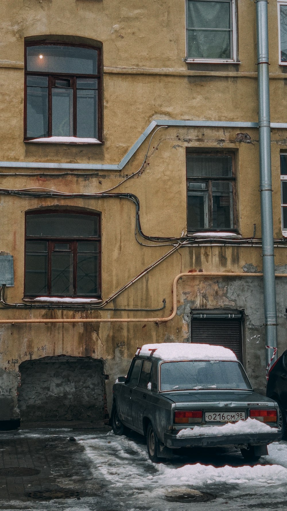 a couple of cars parked in front of a building