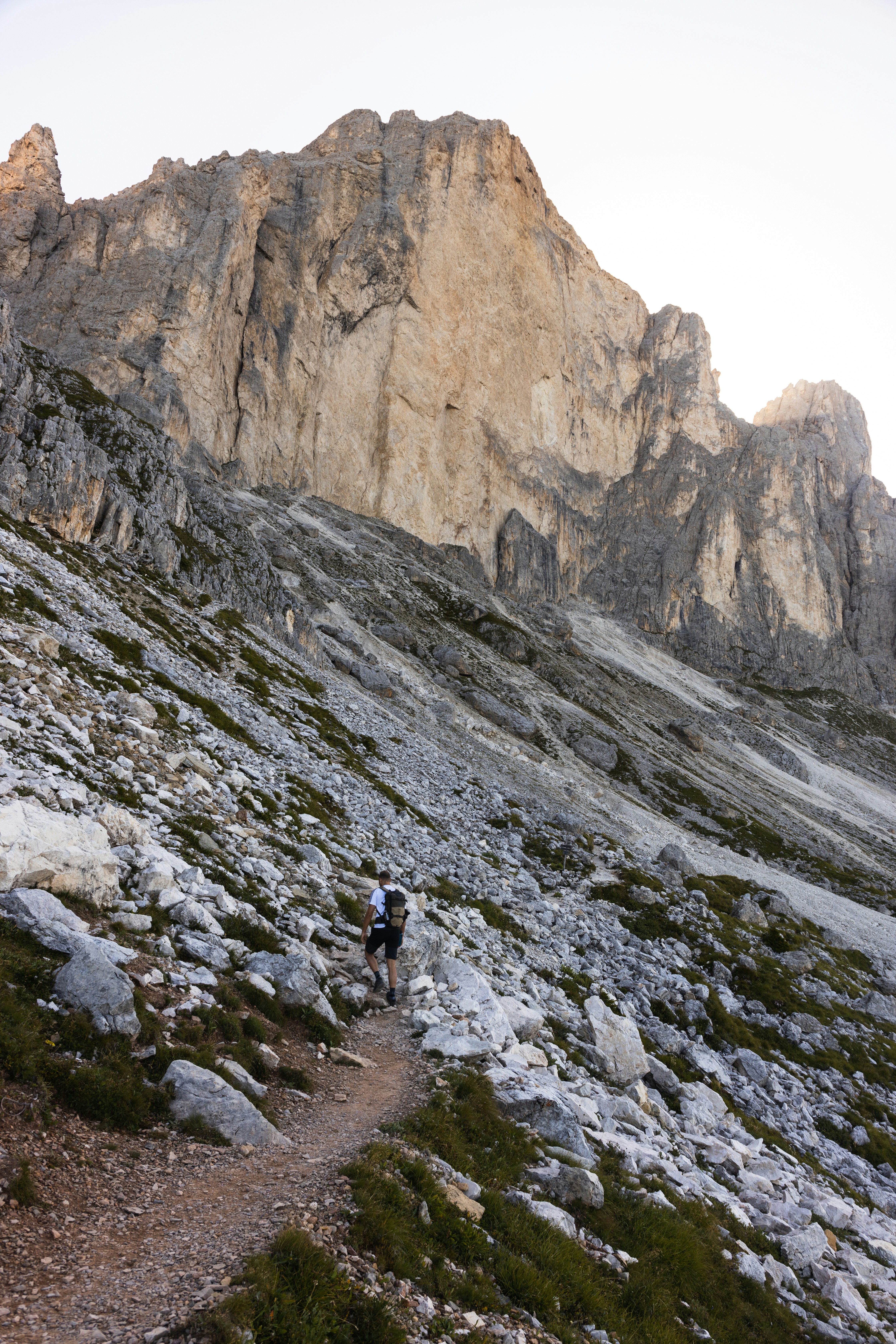 a person hiking up a rocky mountain trail