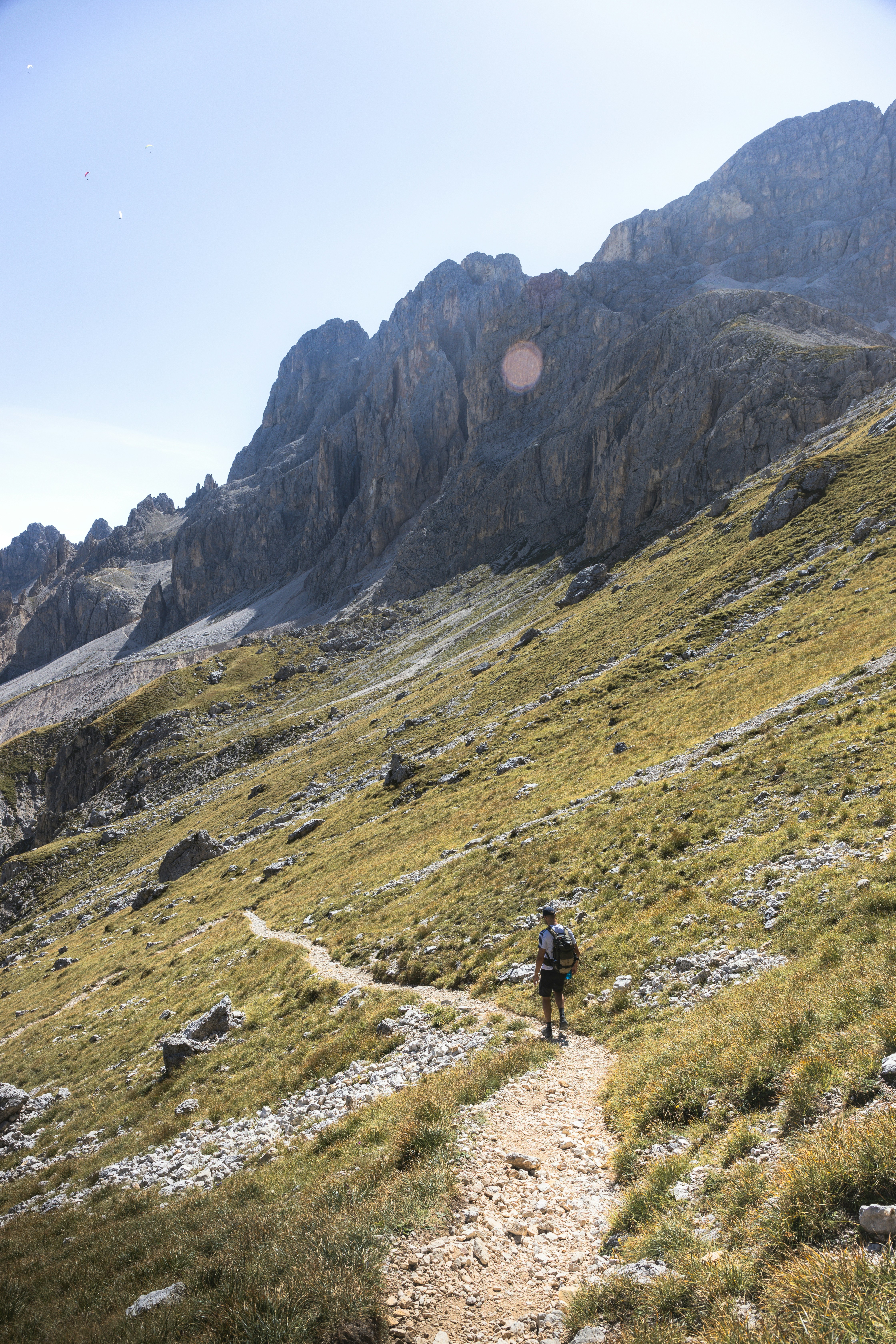 a man hiking up a trail in the mountains