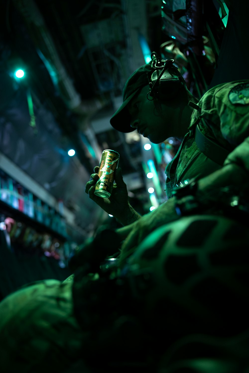 a man in a military uniform holding a can of beer