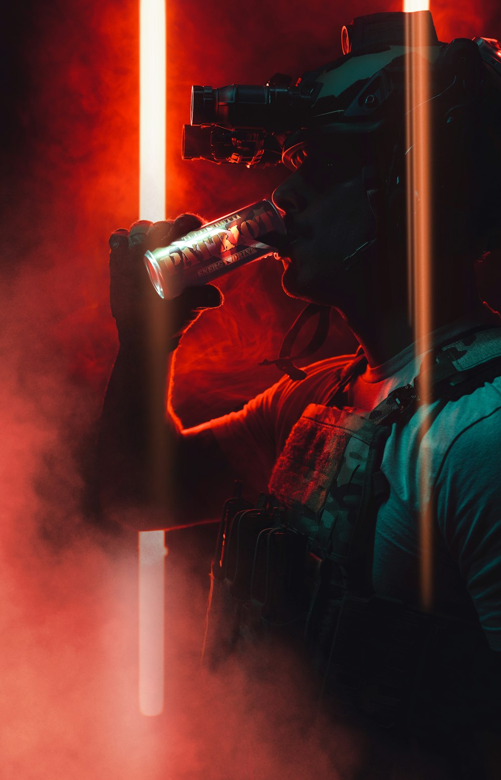 a man holding a camera and drinking from a bottle