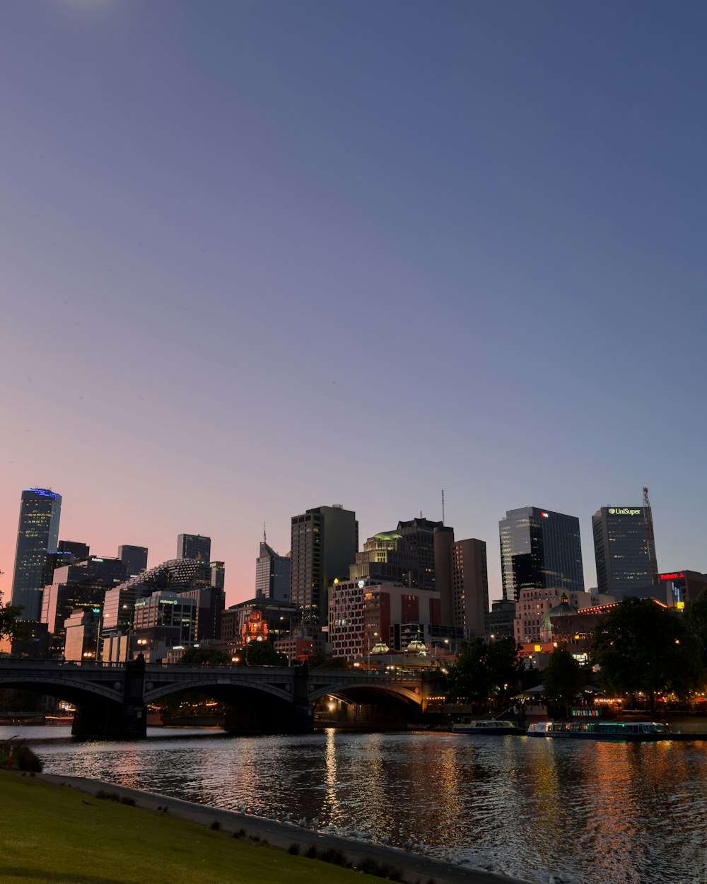 a city skyline with a bridge over a body of water