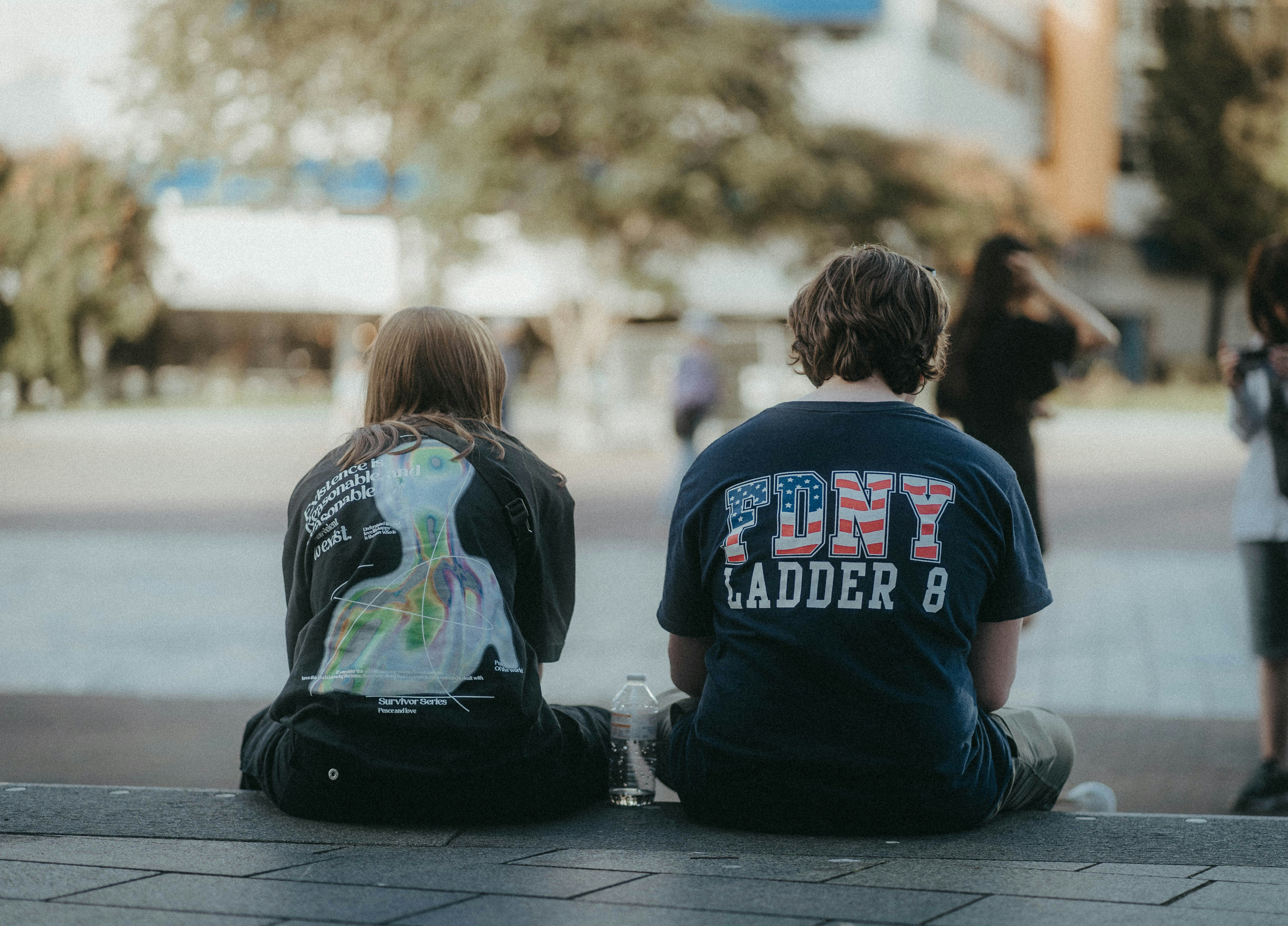 a couple of kids sitting on the ground next to each other