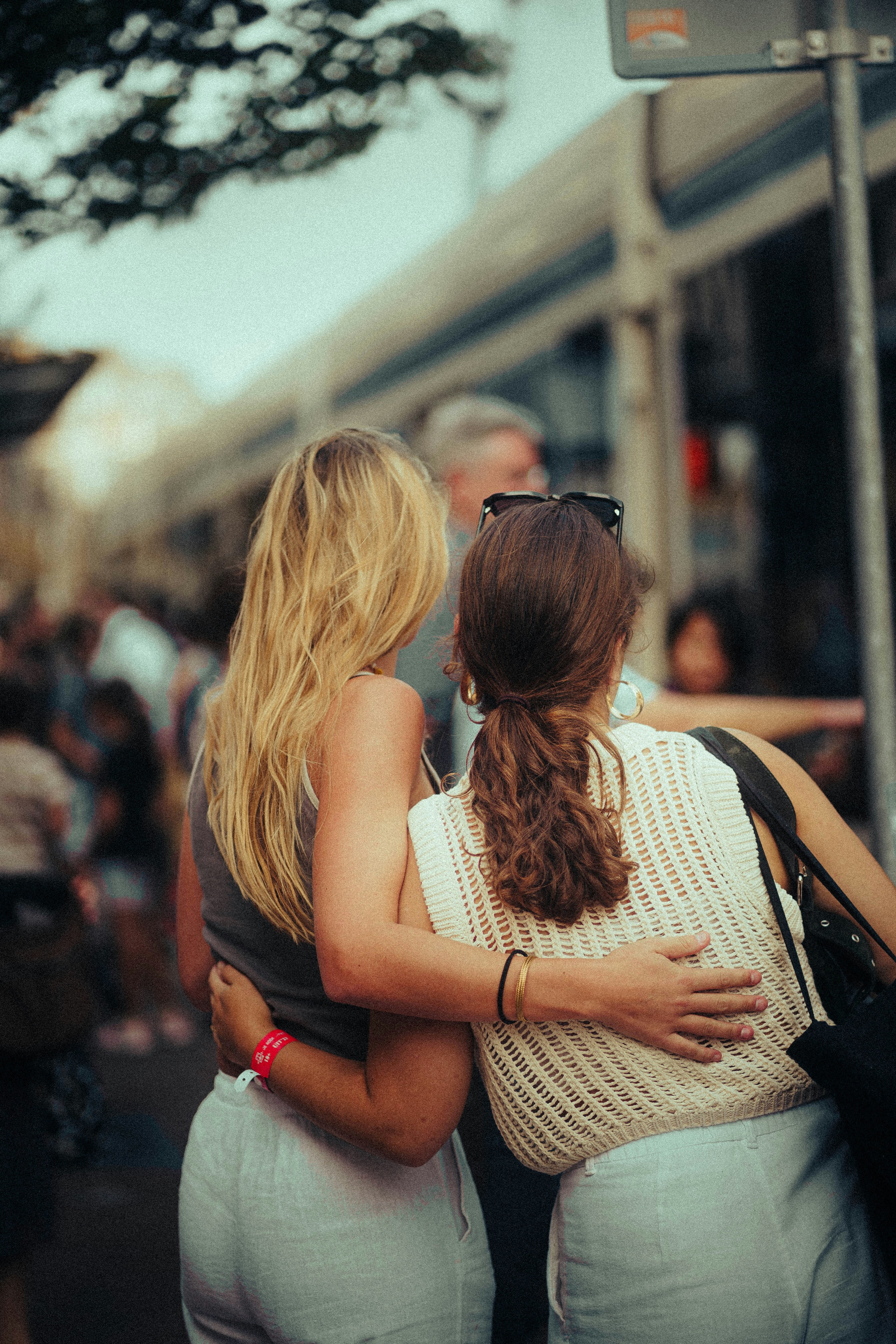 two women hugging each other in front of a crowd of people