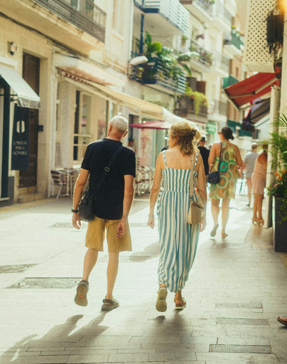 a man and a woman walking down a street