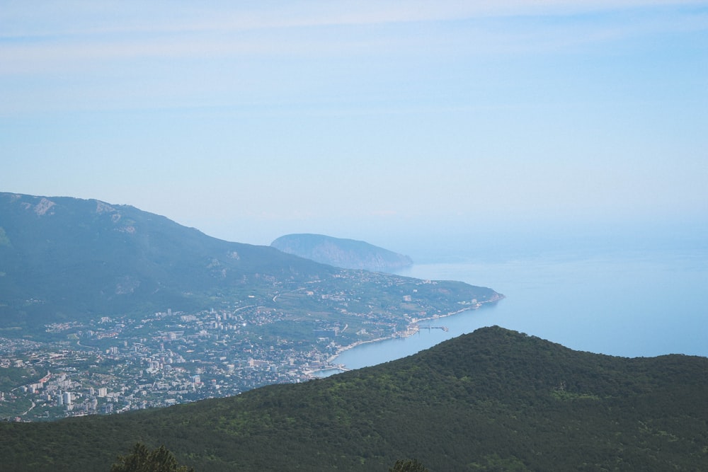 a scenic view of a city and a body of water