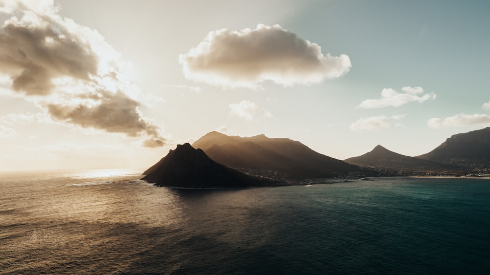 a large body of water with mountains in the background