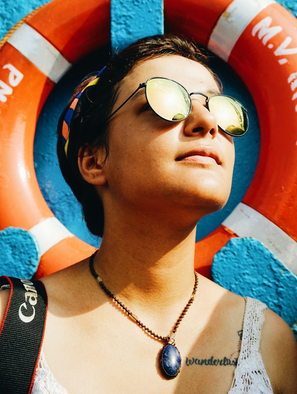 a woman wearing sunglasses and a life preserver