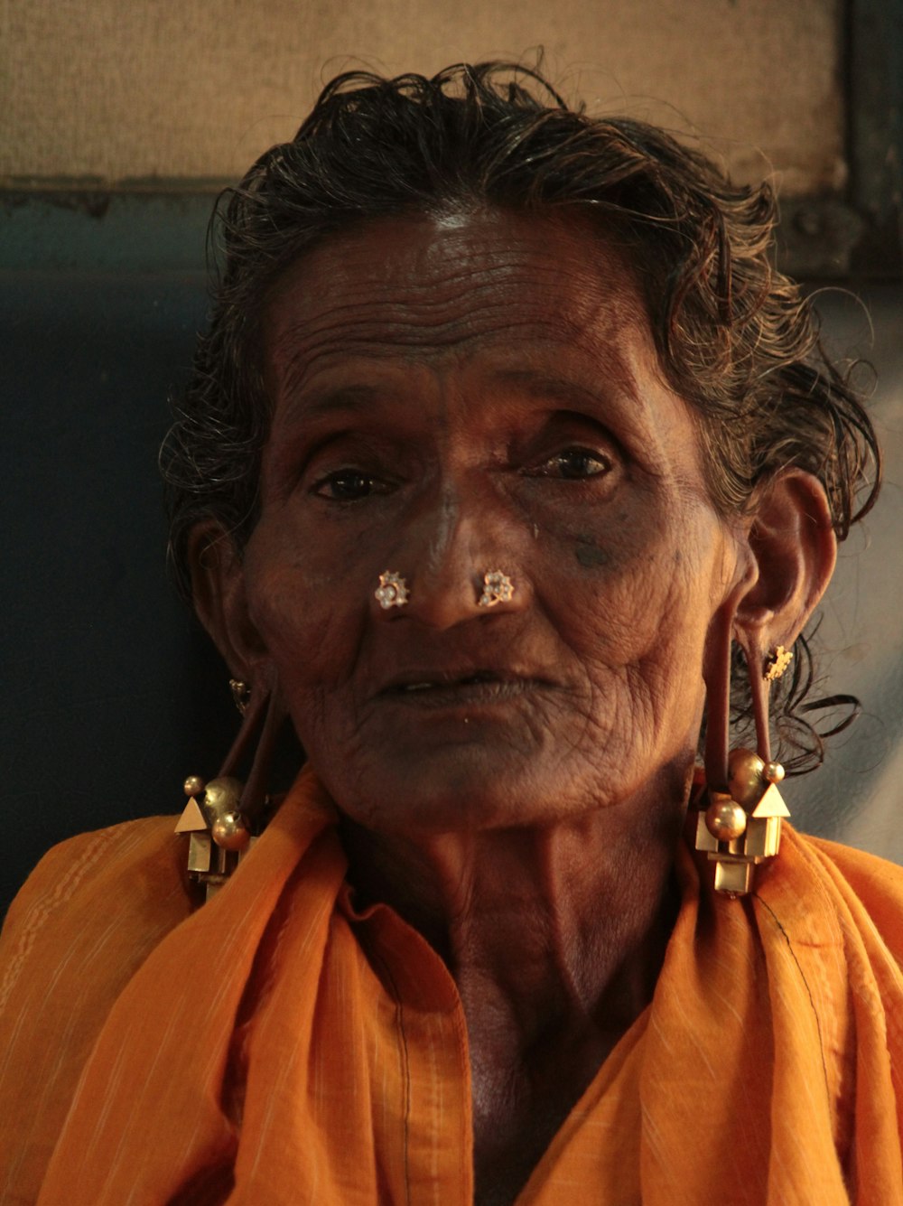 an old woman with piercings on her nose