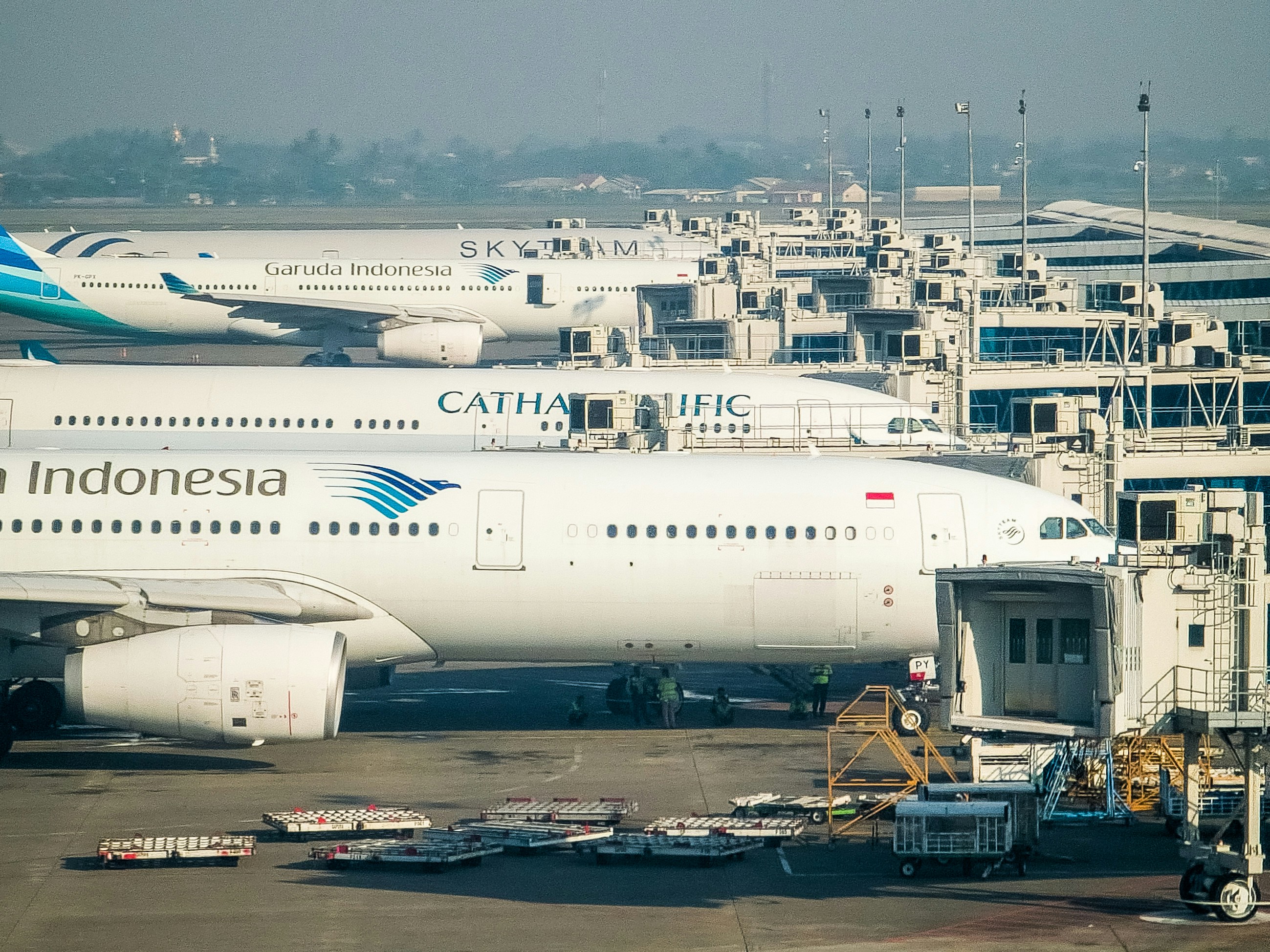 a large jetliner sitting on top of an airport tarmac, 