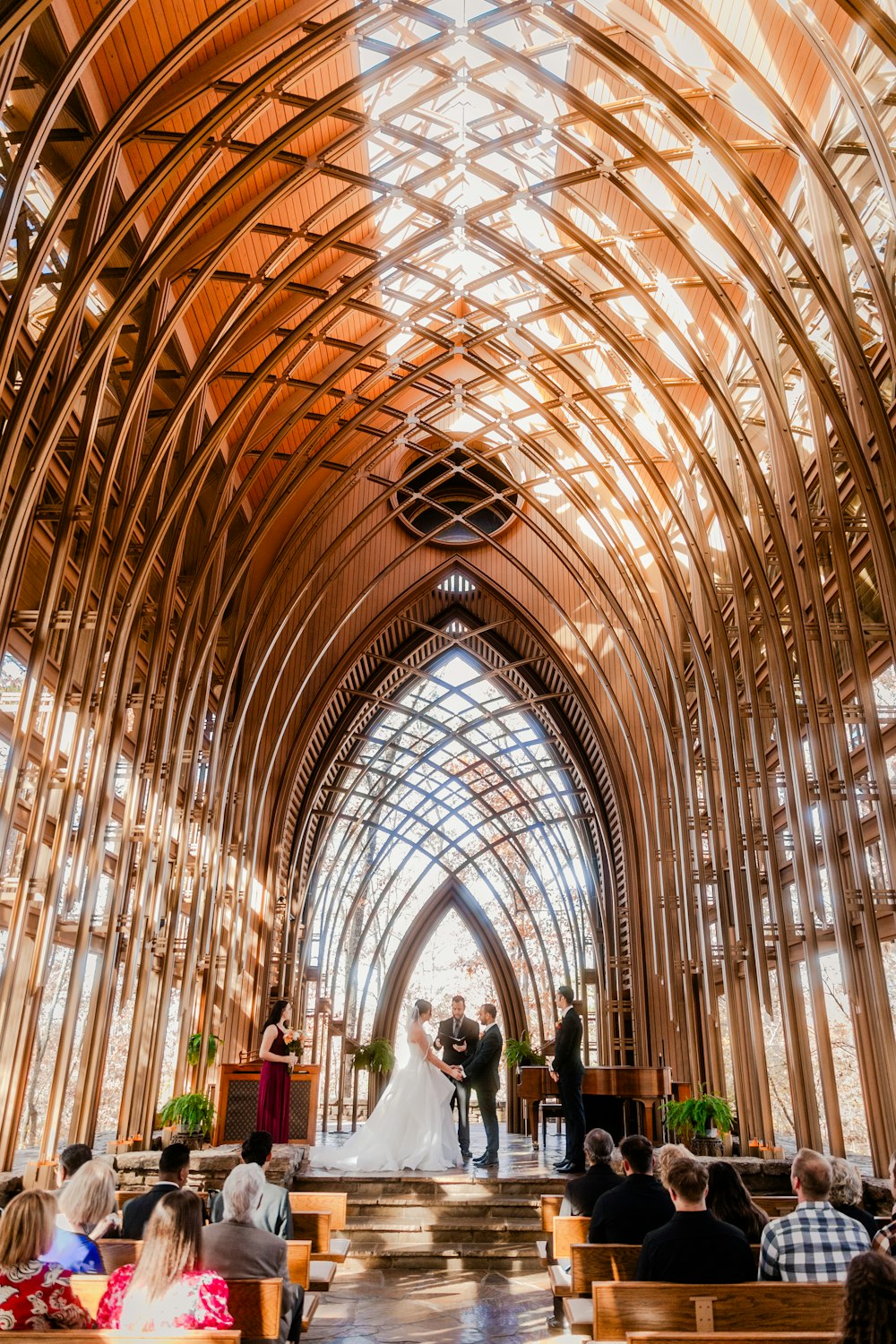 a bride and groom standing at the alter of a church