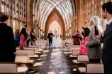 a bride and groom walking down the aisle of a church