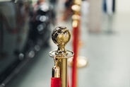 a row of red and gold poles with a golden ball on top