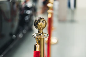 a row of red and gold poles with a golden ball on top