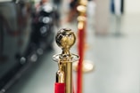 a row of red and gold poles with a golden ball on top