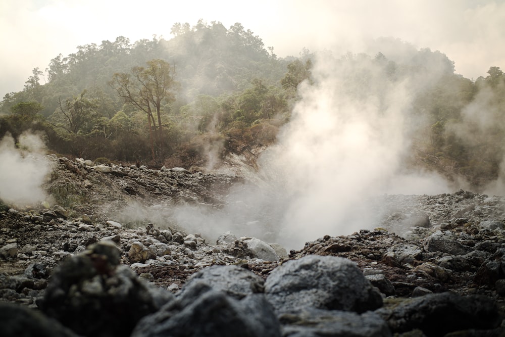 steam rises from the ground in a rocky area
