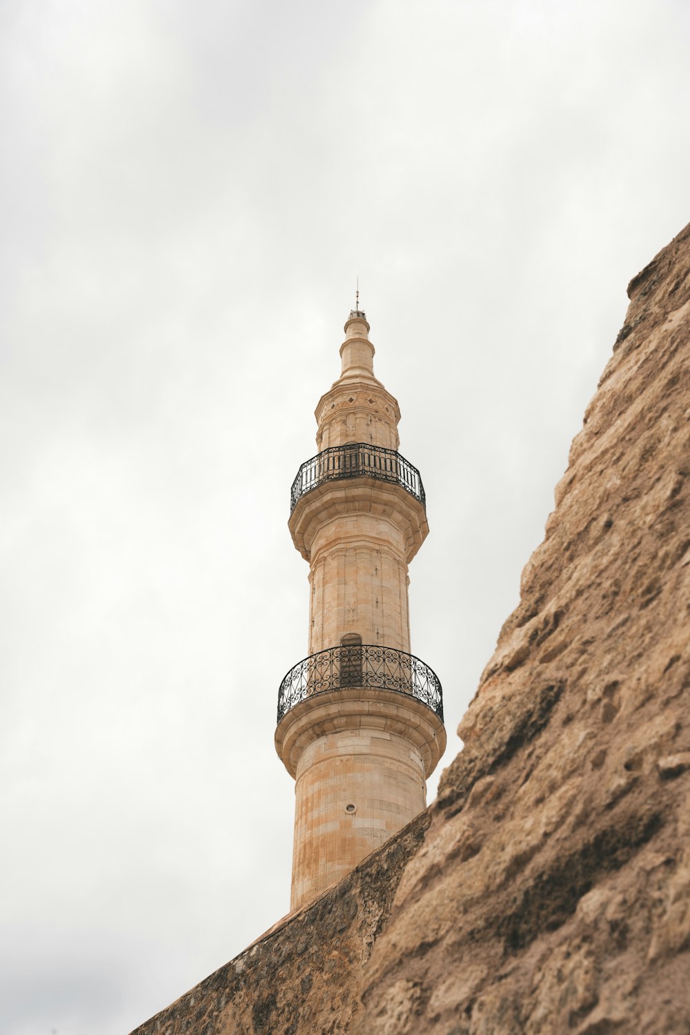 a tall tower with a balcony on top of it