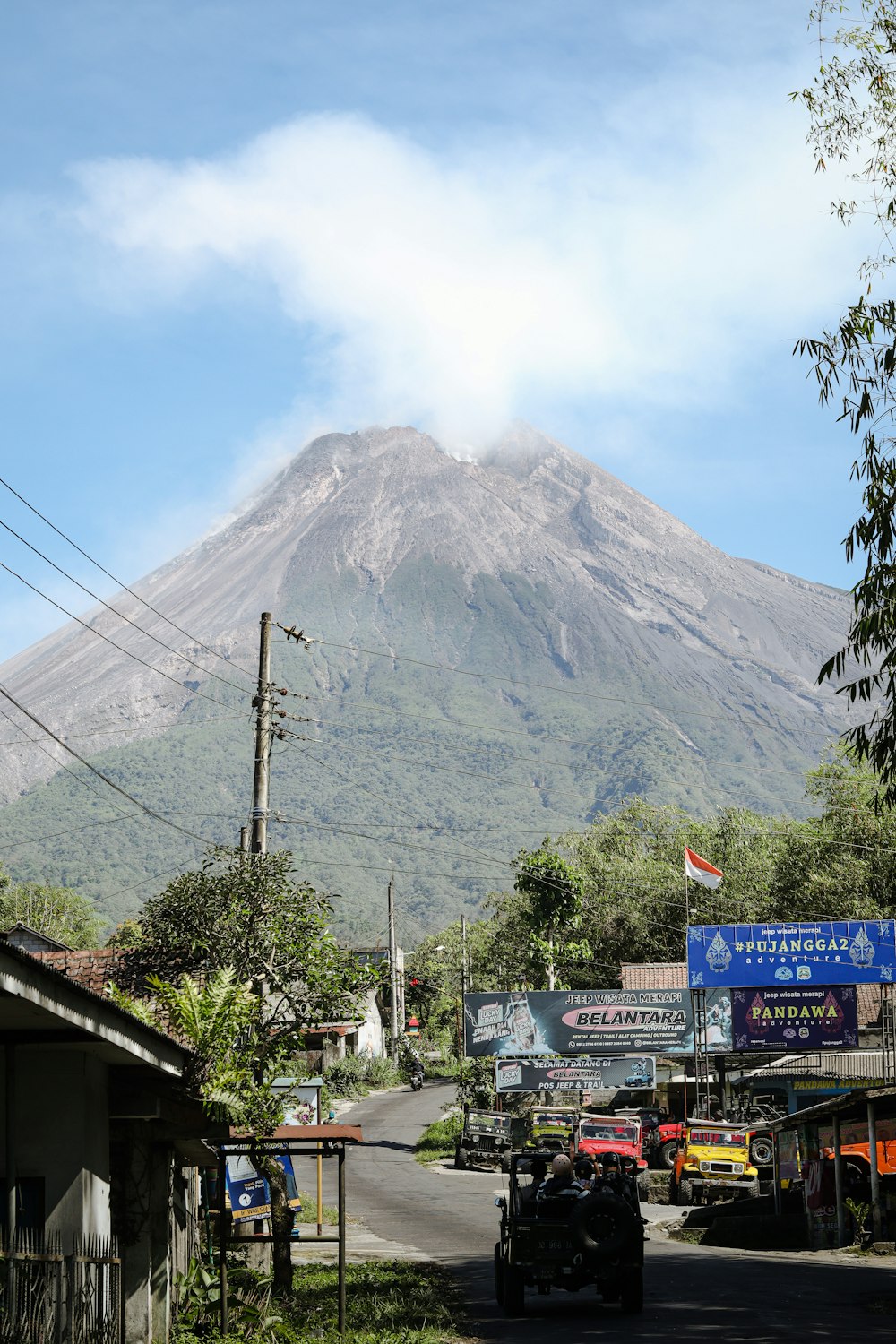 a very tall mountain towering over a small town