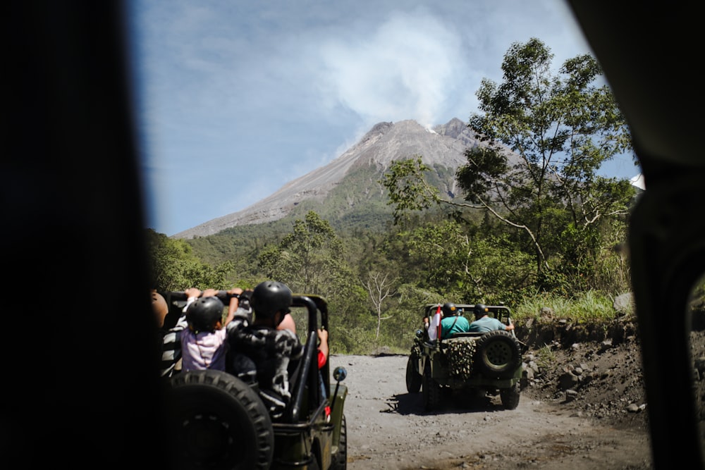 a group of people riding on the back of four wheelers