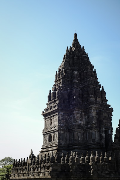 a very tall tower with a clock on it's side