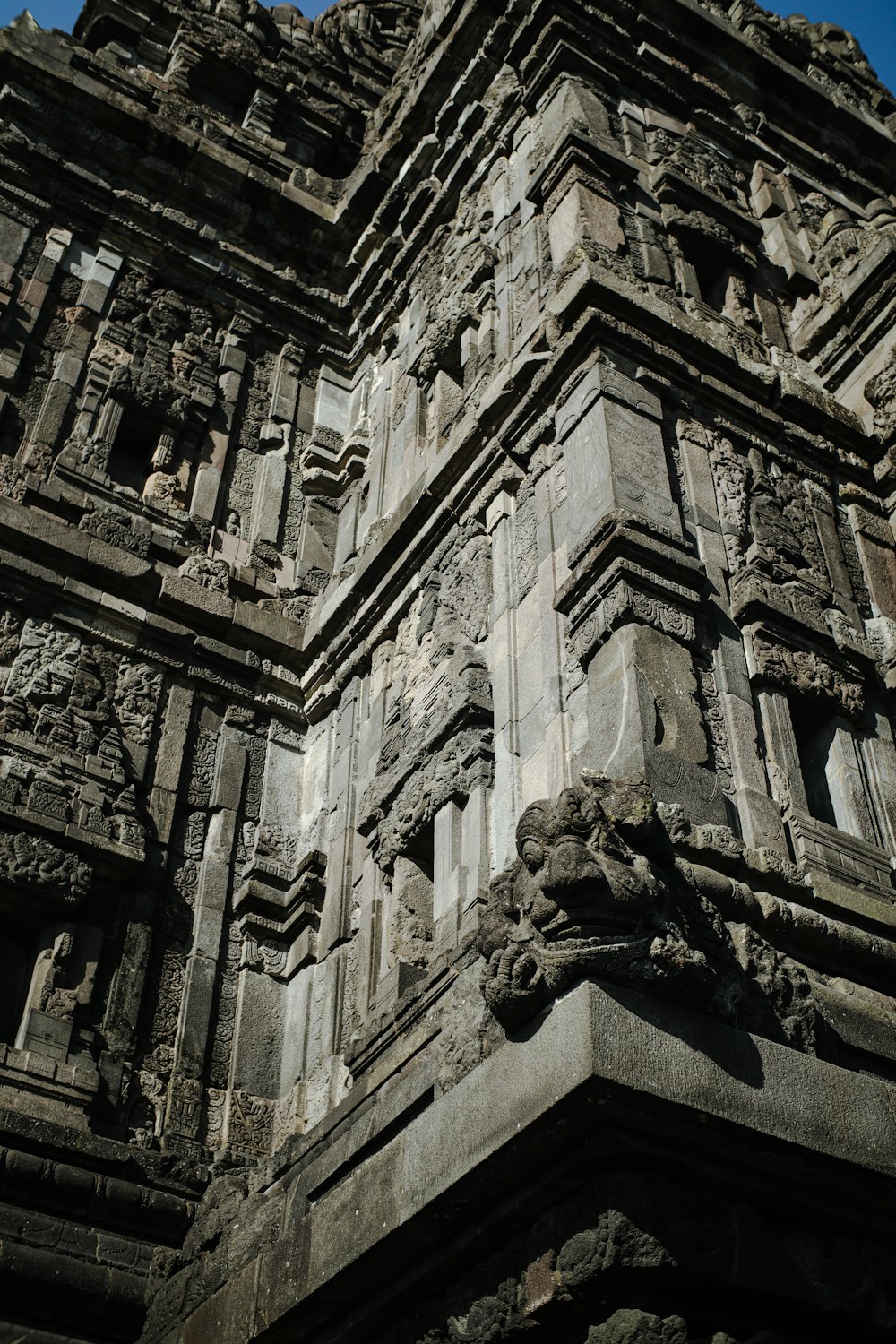 a tall building with carvings on the side of it