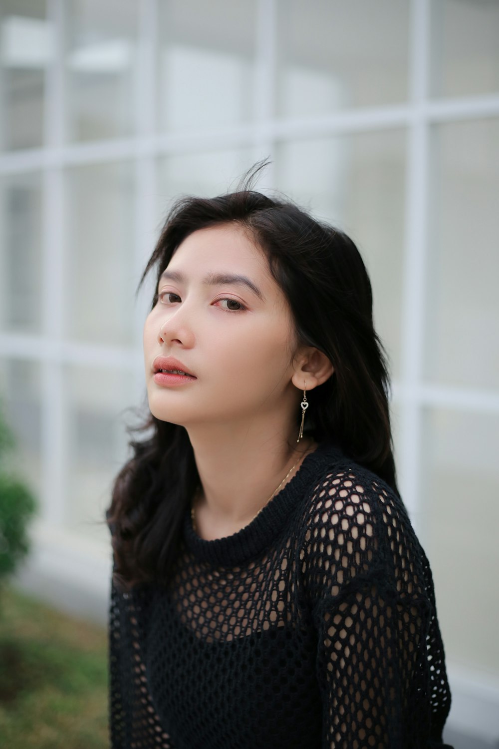 a woman with long hair wearing a black top