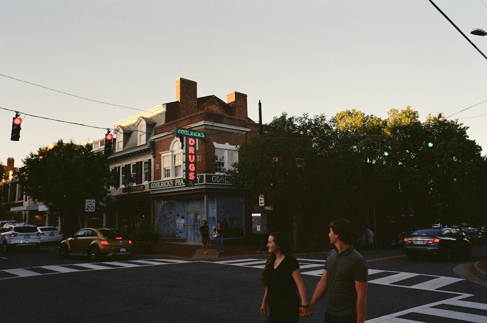 a man and a woman walking across a street