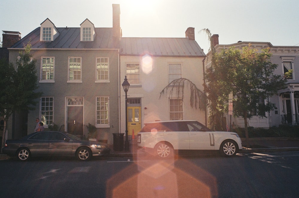 a white car is parked in front of a house