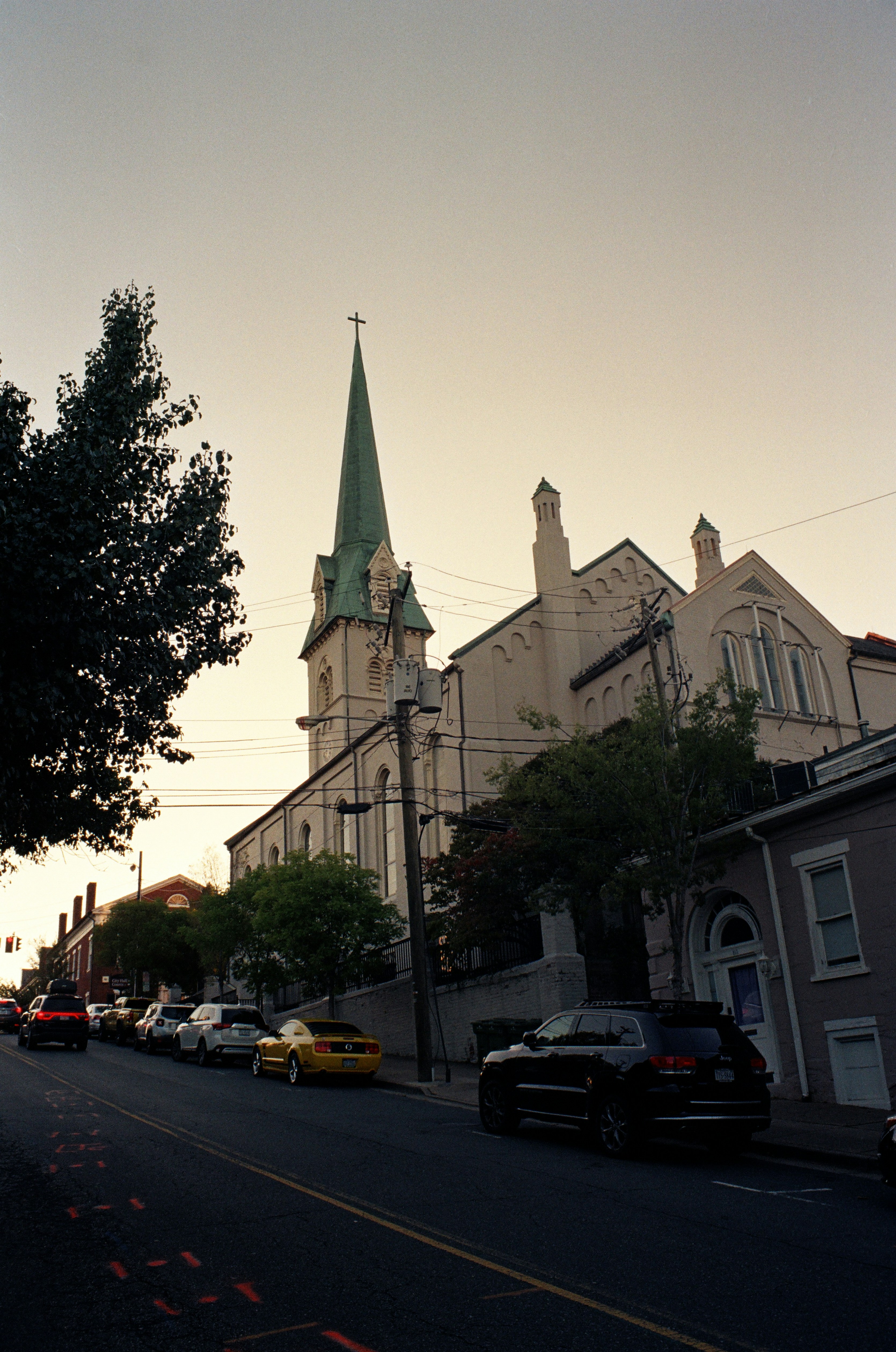 a city street with a church steeple in the background