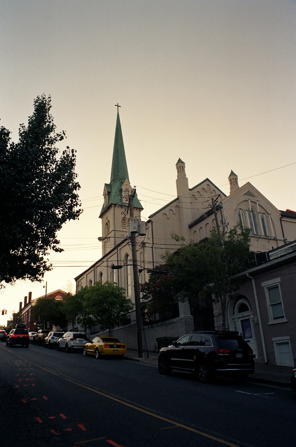 a city street with a church steeple in the background