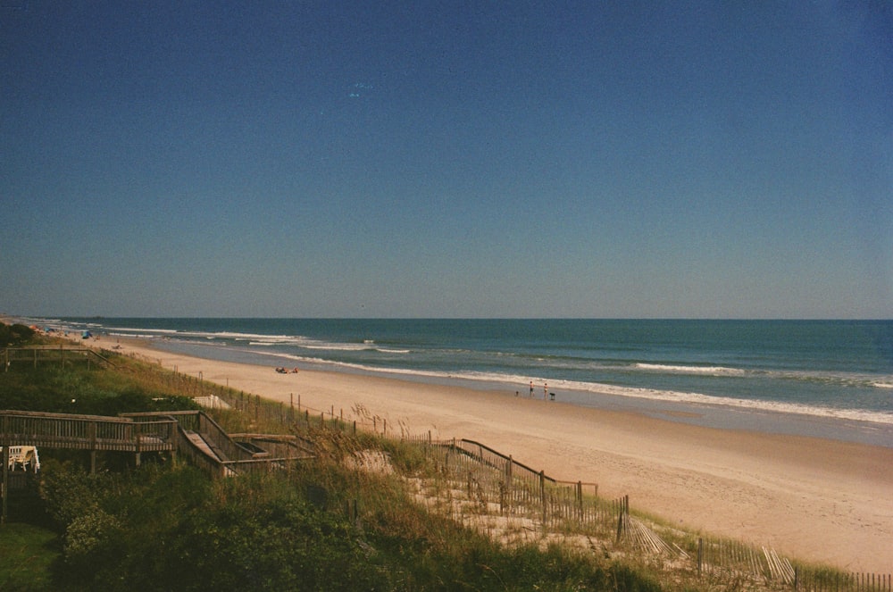 a view of a beach and ocean from the top of a hill