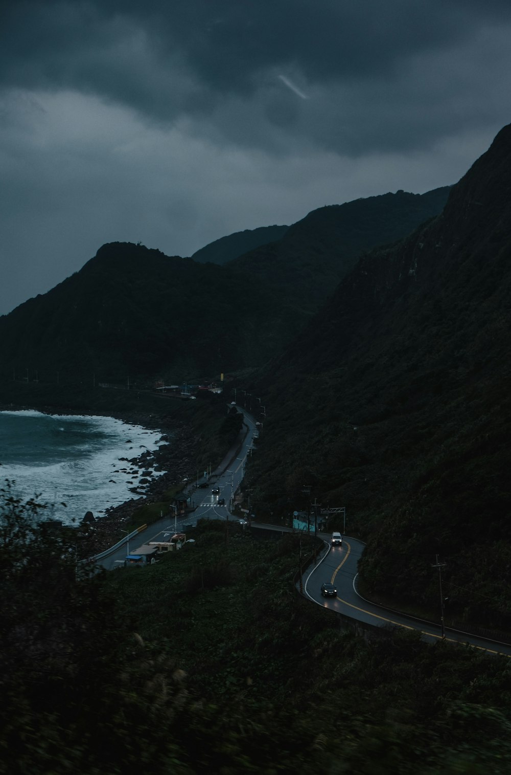 a long road next to a large body of water