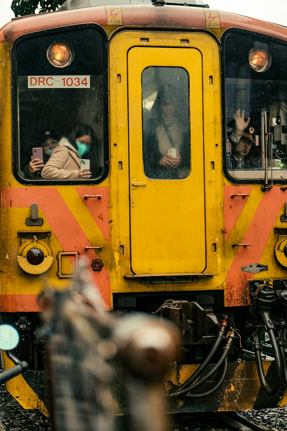 a yellow and red train traveling down train tracks