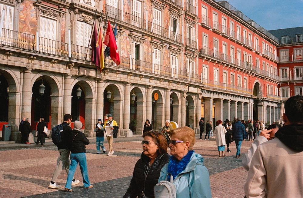 a group of people standing in front of a building