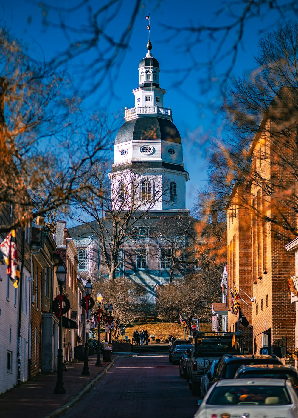 a large clock tower towering over a city street