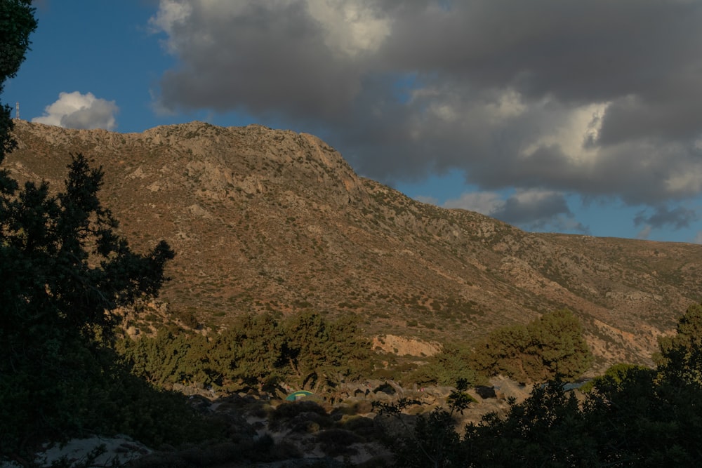 a view of a mountain with clouds in the sky