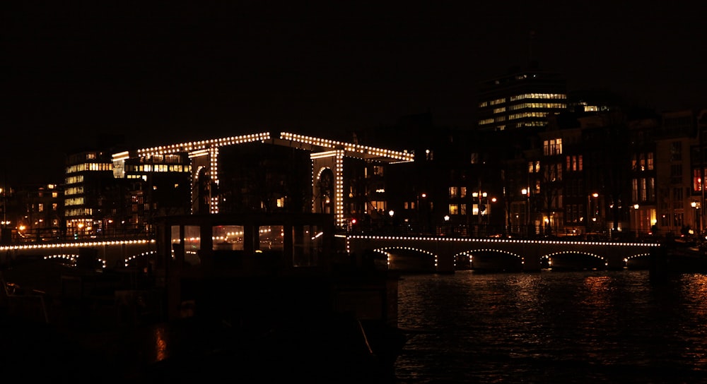 a city at night with a bridge and lights