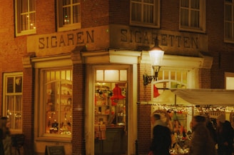 a group of people standing outside of a store at night