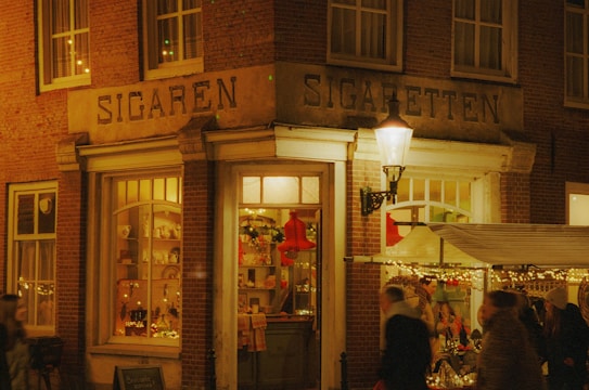 a group of people standing outside of a store at night