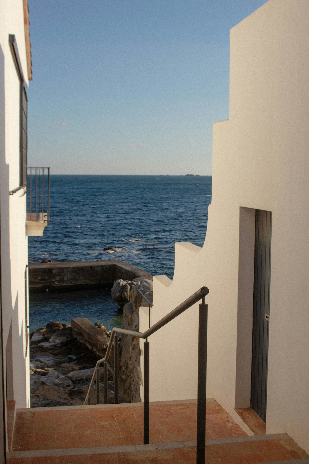 a stairway leading to the ocean from a building