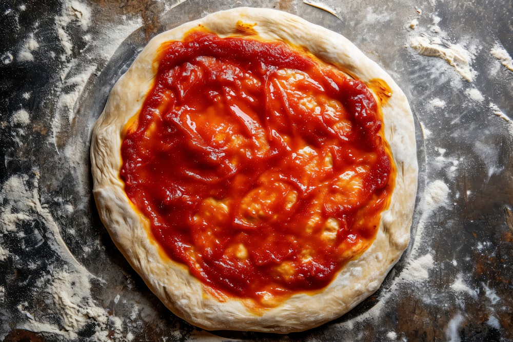 an uncooked pizza sitting on top of a table