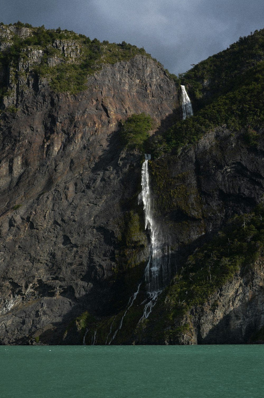 a large waterfall on the side of a mountain
