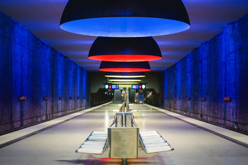 a long hallway with blue and red lights