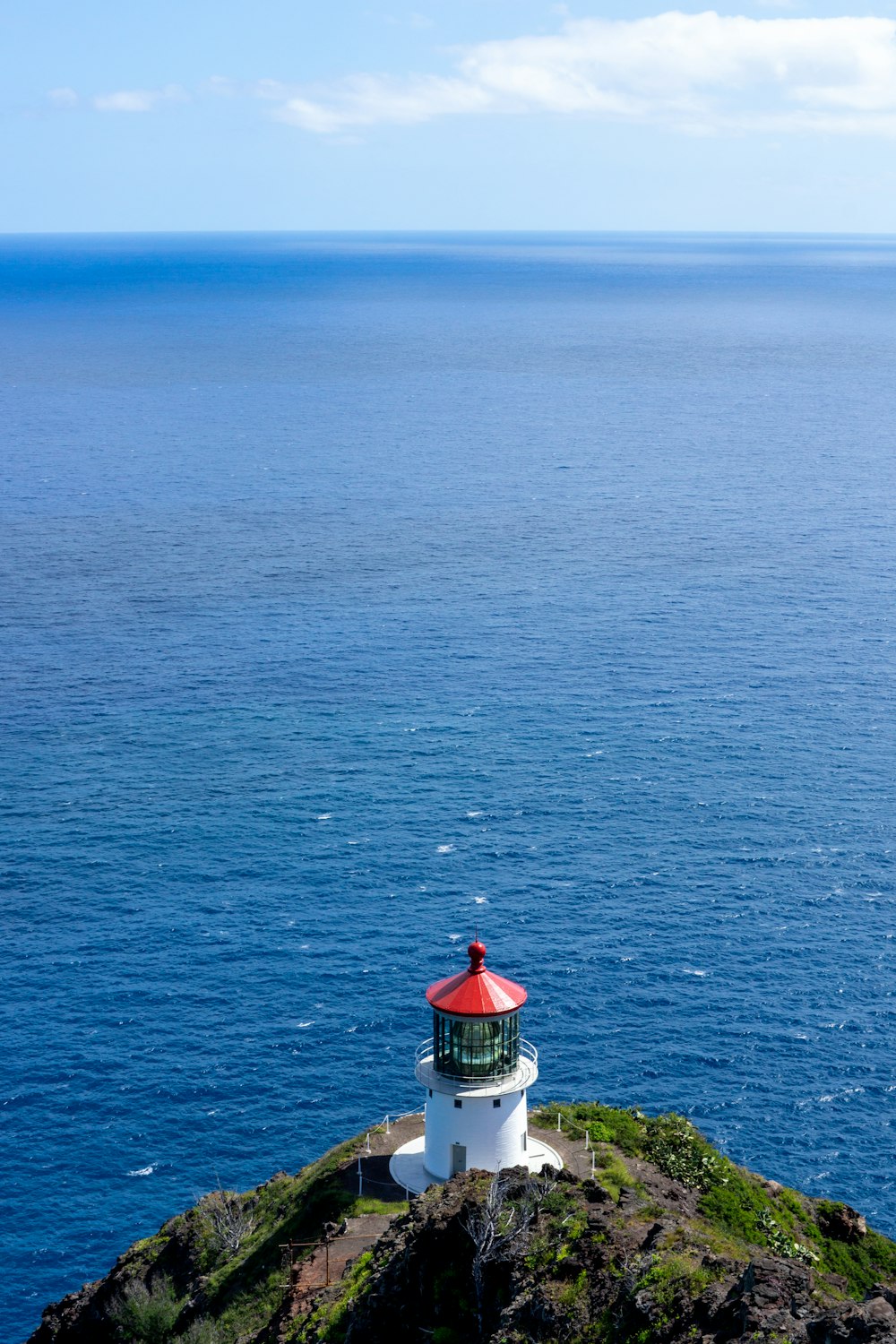 a light house sitting on top of a cliff near the ocean