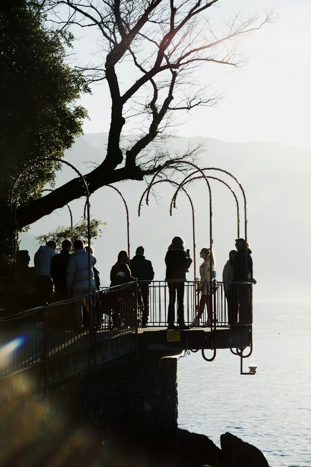 a group of people standing on top of a bridge