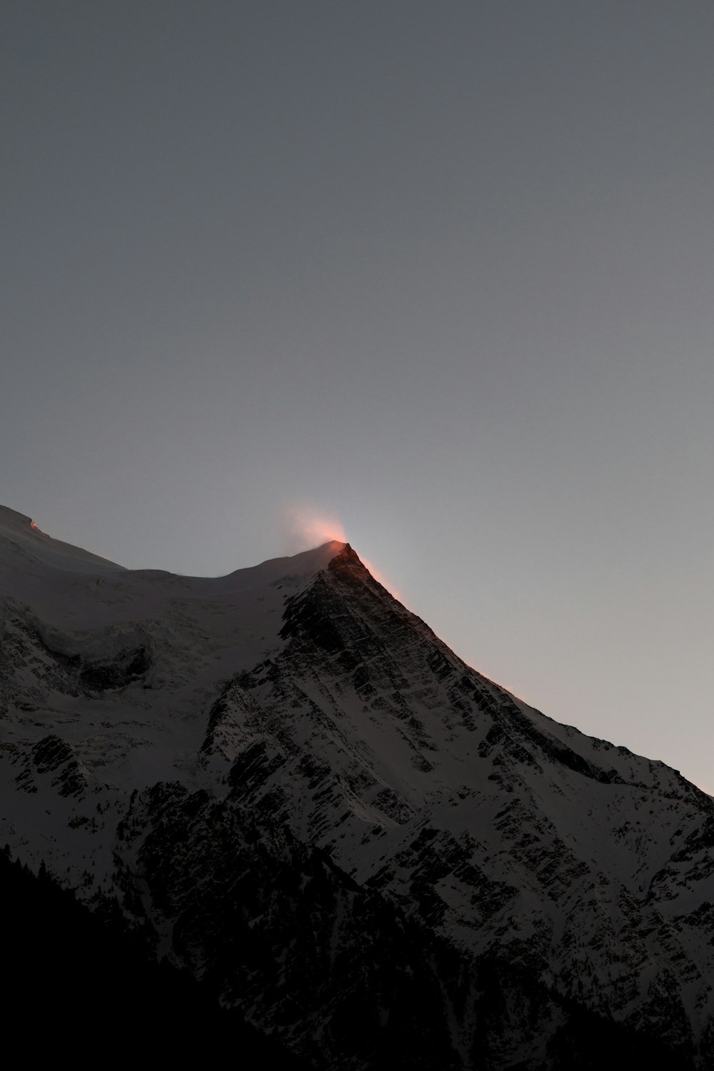 a very tall mountain with a bright light on top of it